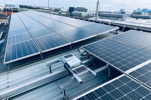 solar panels with dust analysis systems on the rooftop of a building in an industrial facility