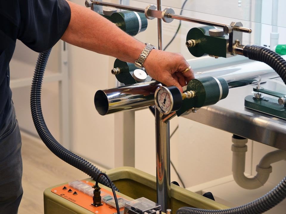 middle-aged gentleman calibrating a measuring device for accurate readings, during an inspection
