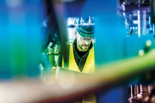 close-up of an employee in-between machines