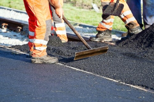 Roadworkers laying Kiwa tested asphalt