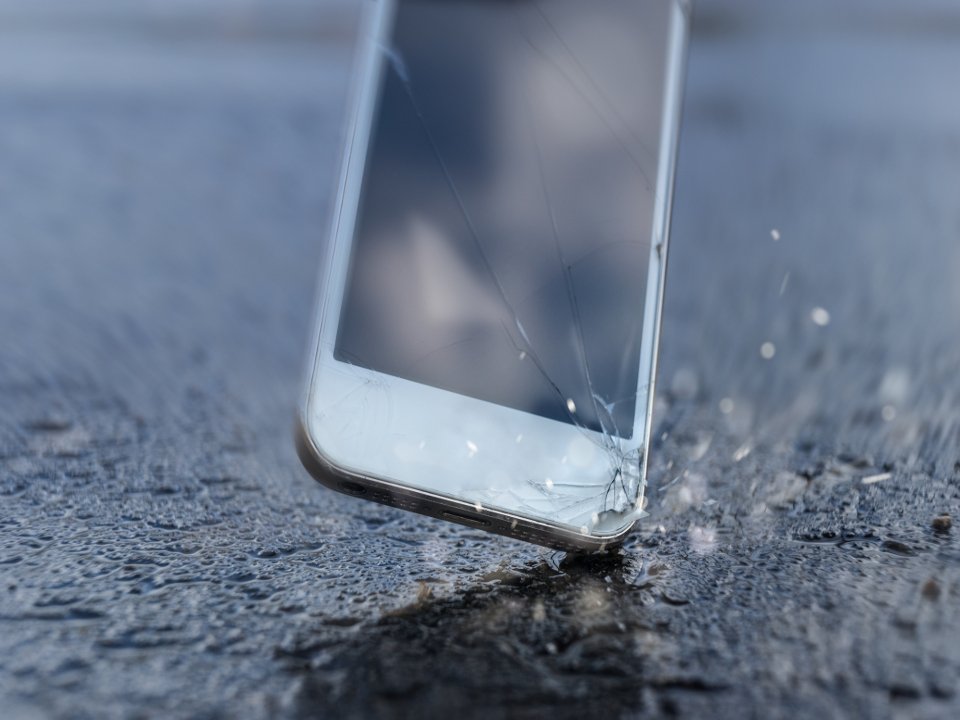 Cracked smartphone screen after drop-test on concrete floor