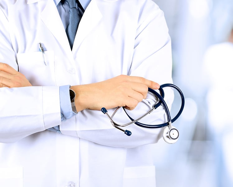 Doctor holding a stethoscope wearing a white coat, depicting a medical professional in a healthcare setting